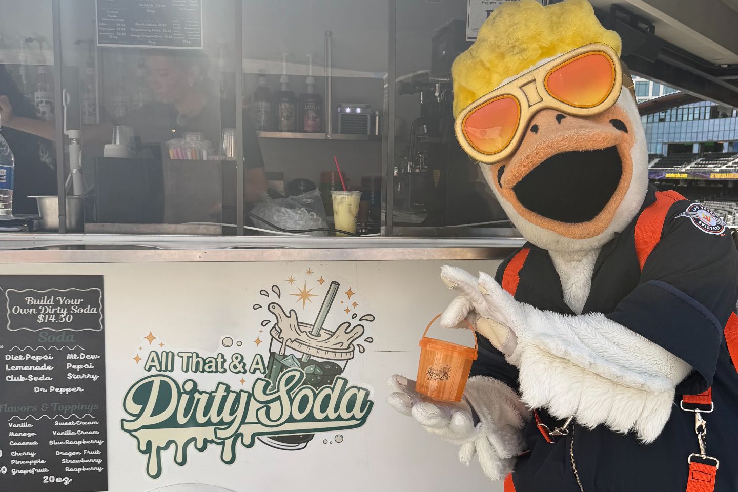 All That & A Dirty Soda mascot holding a custom dirty soda at the Las Vegas Ballpark concession stand in Las Vegas, NV.