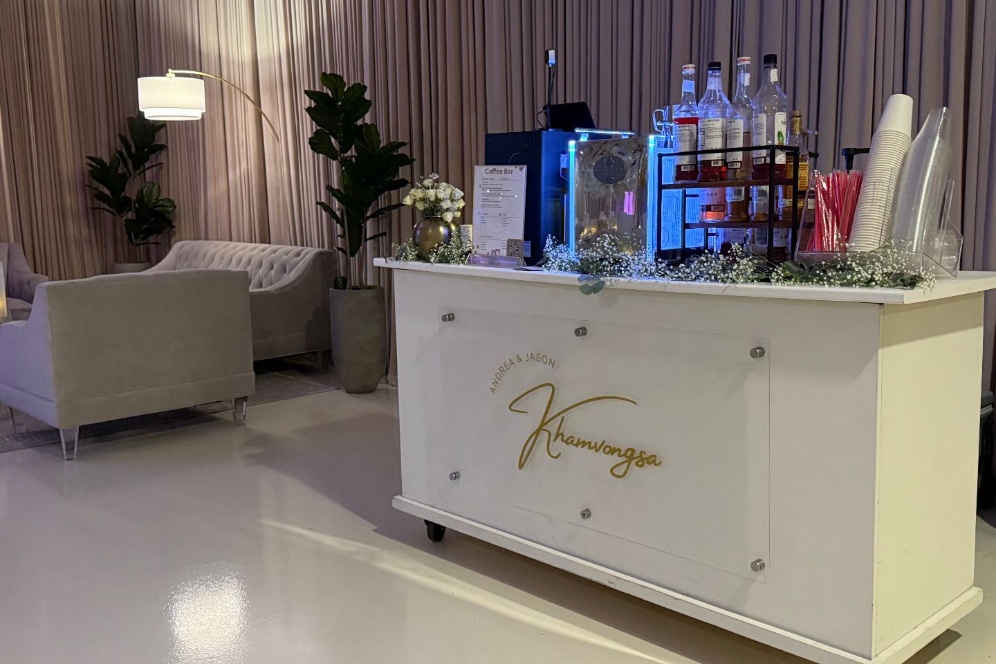 A mobile coffee bar set up at a venue with custom branding on the front.