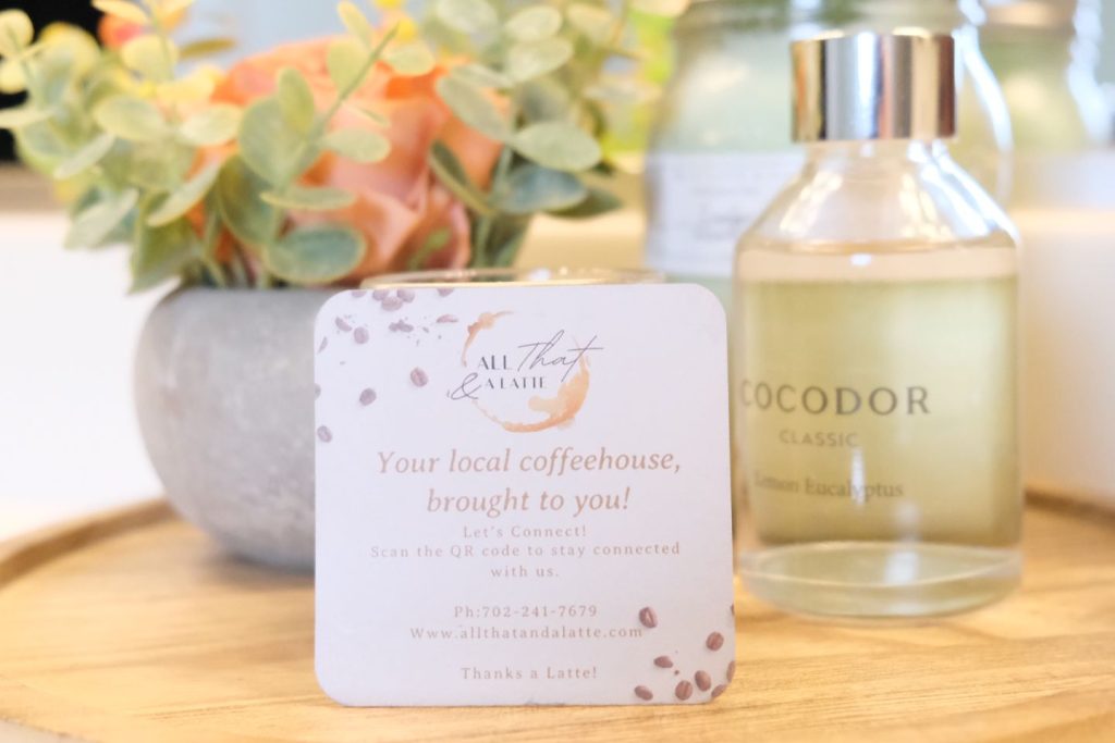 Custom branding on a white card among wellness retreat coffee bar decor.