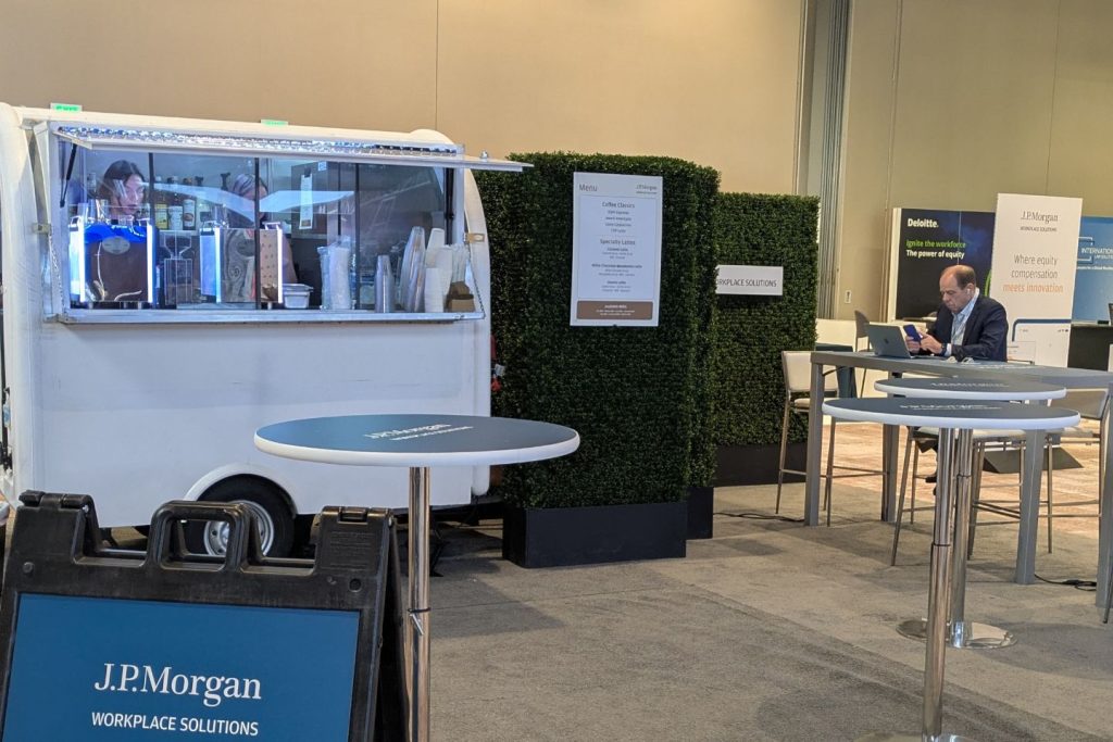 White mobile coffee trailer parked at special event.