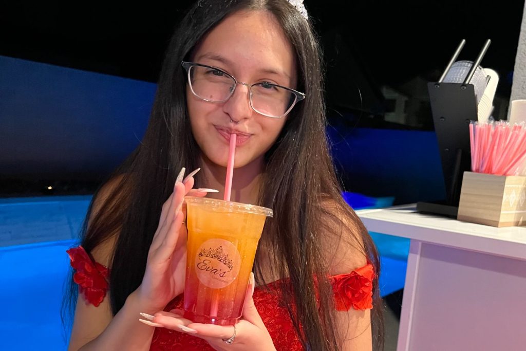 A girl celebrating her Quinceañera with a drink from All That & A Latte.